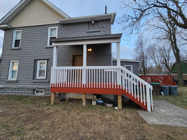 back of house featuring a wooden deck