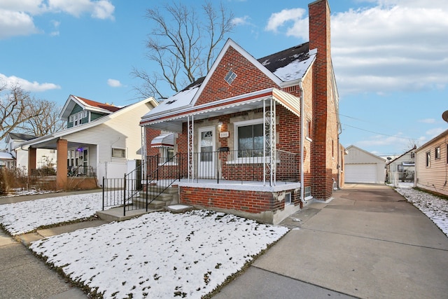 bungalow-style home with an outbuilding, a porch, and a garage