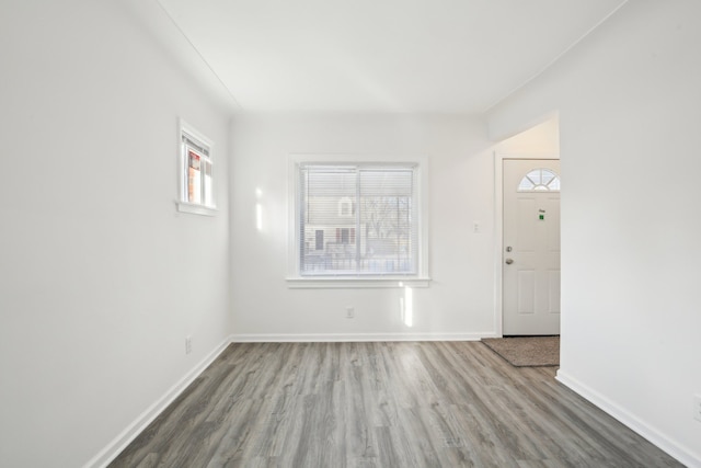 unfurnished room with a healthy amount of sunlight and hardwood / wood-style flooring