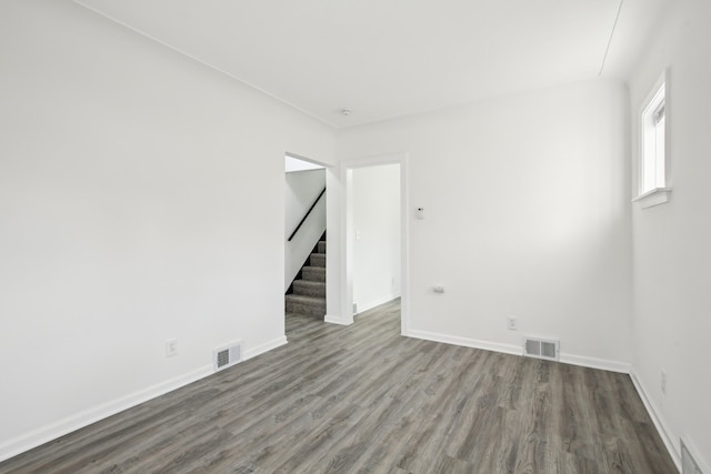 spare room with dark wood-type flooring