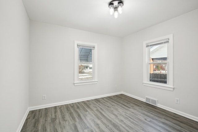 spare room featuring dark hardwood / wood-style floors