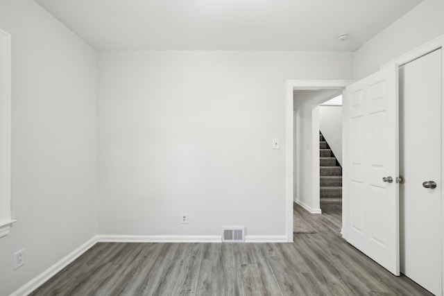 spare room featuring wood-type flooring