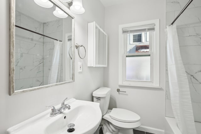 full bathroom featuring shower / tub combo, toilet, and sink