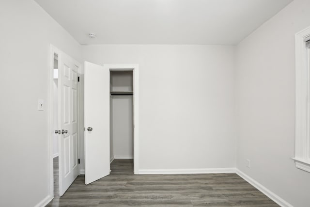 unfurnished bedroom featuring dark hardwood / wood-style flooring