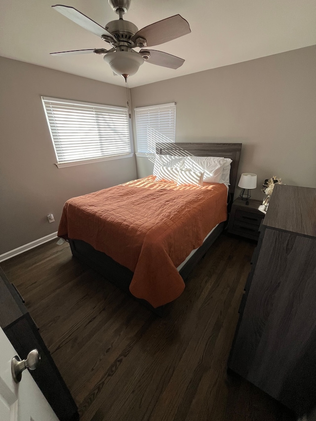 bedroom with ceiling fan and dark wood-type flooring