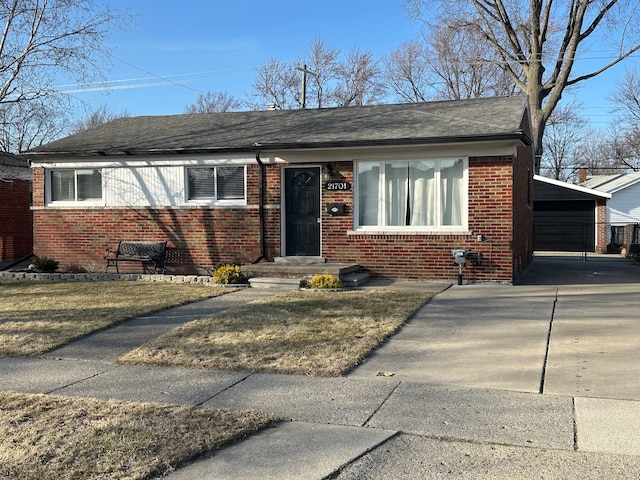 view of front facade with brick siding, a garage, and roof with shingles