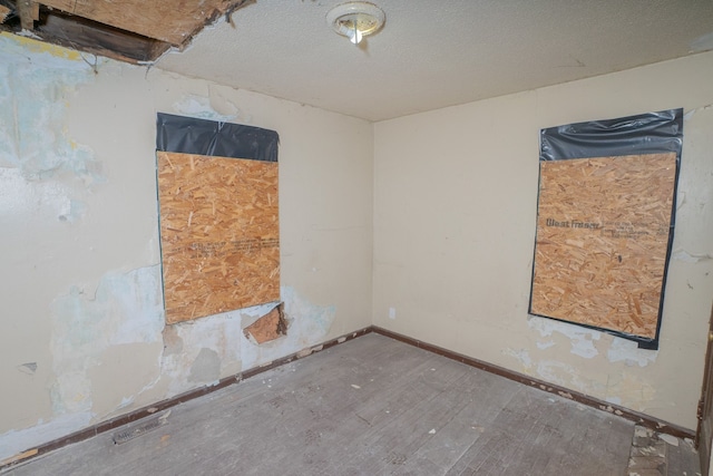 16100 Liberal St, Detroit, MI 48205 - unfurnished room with wood finished floors, baseboards, and a textured ceiling