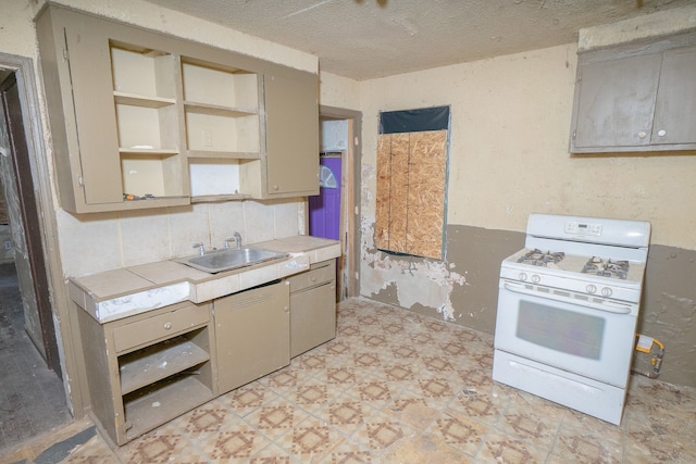 kitchen featuring decorative backsplash, a textured ceiling, sink, tile counters, and white gas stove