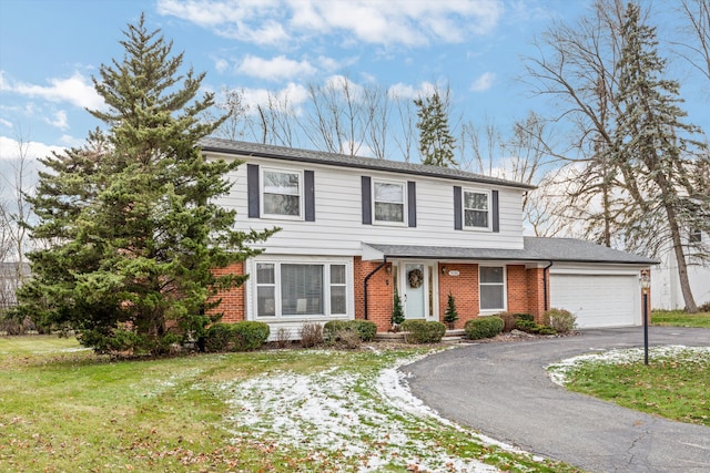 view of front property with a garage and a front lawn