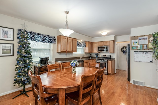 dining room featuring light hardwood / wood-style floors and sink