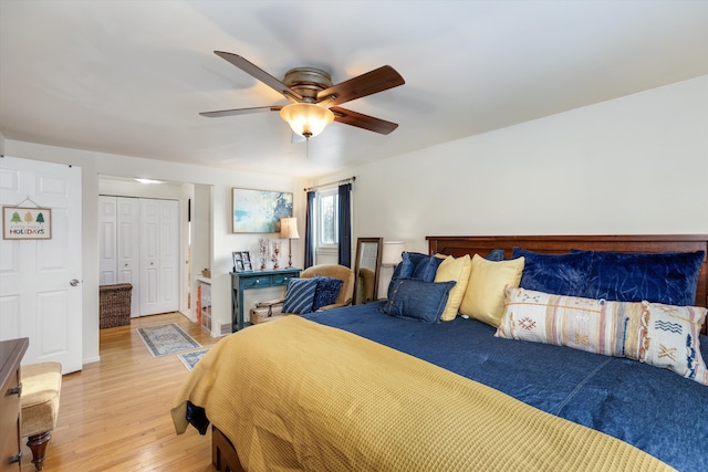 bedroom featuring a closet, light hardwood / wood-style flooring, and ceiling fan