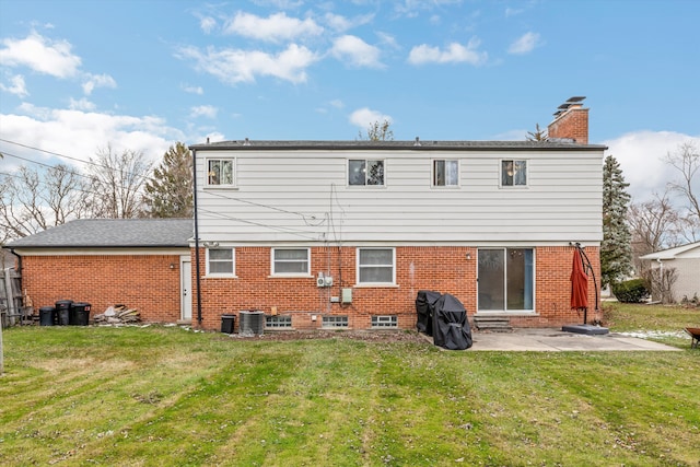 rear view of property with a lawn, cooling unit, and a patio