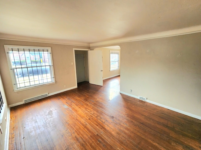 unfurnished room featuring dark hardwood / wood-style flooring and ornamental molding