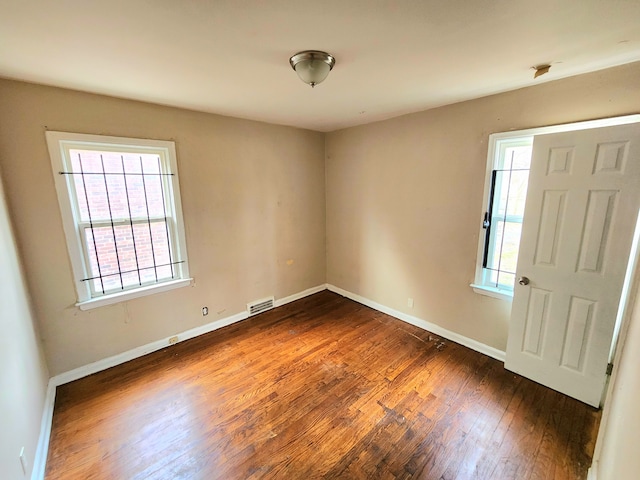 unfurnished room featuring dark hardwood / wood-style flooring