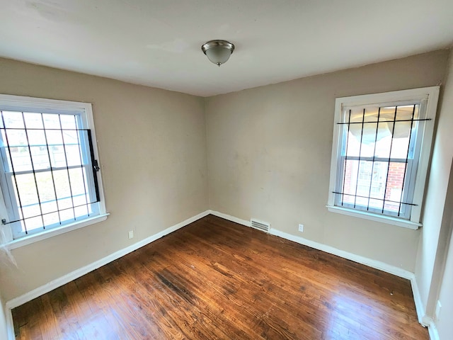 spare room with dark wood-type flooring