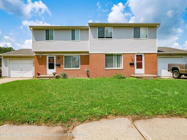 view of front of home with a front lawn and a garage