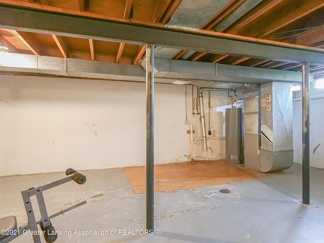 basement featuring heating unit and water heater