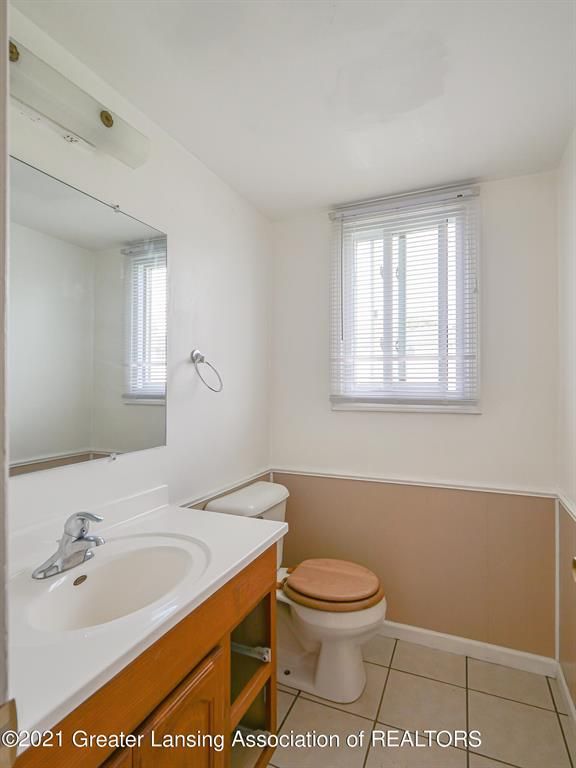 bathroom featuring tile patterned flooring, vanity, and toilet