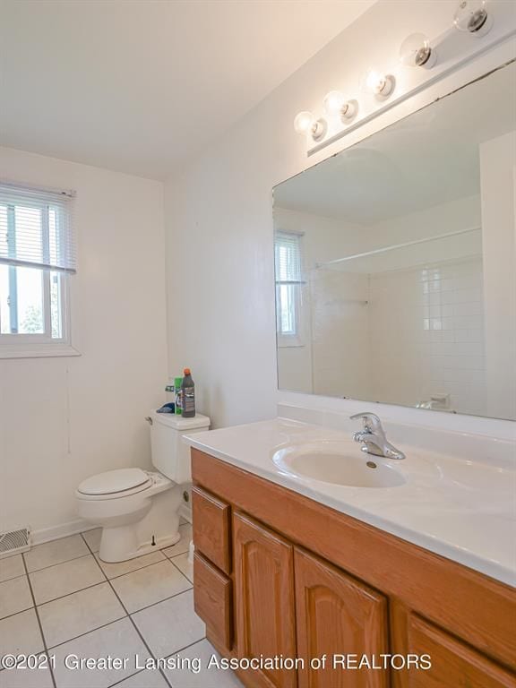 bathroom featuring tile patterned flooring, vanity, and toilet