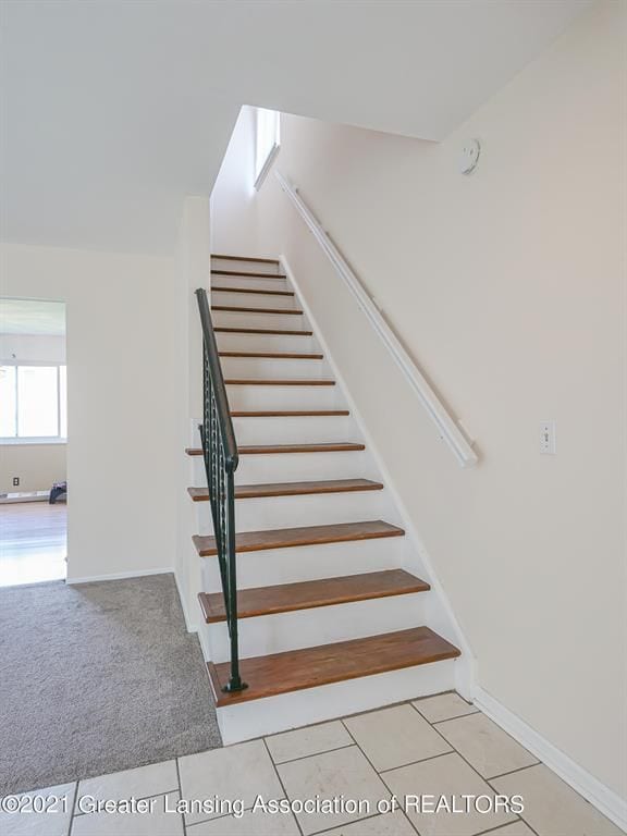 stairs with tile patterned flooring