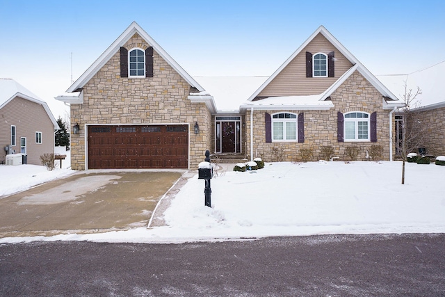 view of property with central AC unit and a garage