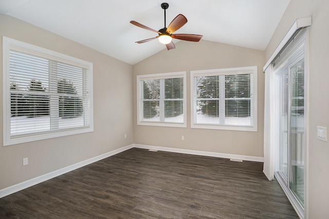 empty room featuring ceiling fan, dark hardwood / wood-style floors, and vaulted ceiling