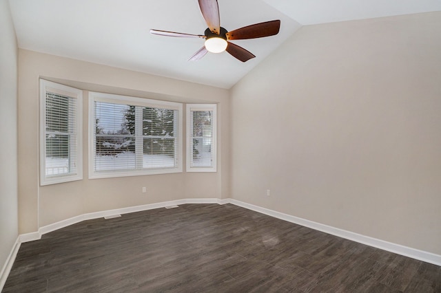 spare room featuring ceiling fan, dark hardwood / wood-style flooring, and vaulted ceiling