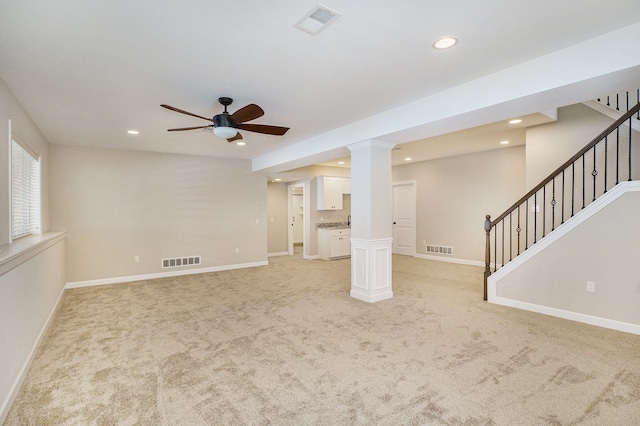 unfurnished living room featuring ceiling fan and light colored carpet