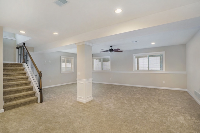 basement featuring light colored carpet and ceiling fan