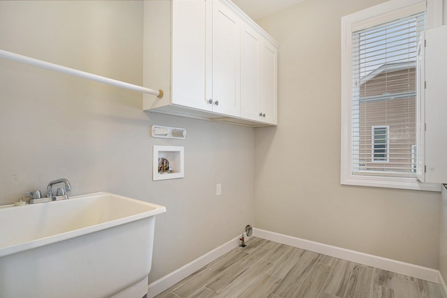 laundry room featuring sink, cabinets, light hardwood / wood-style flooring, gas dryer hookup, and hookup for a washing machine