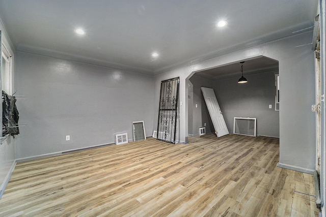 spare room featuring light hardwood / wood-style flooring and ornamental molding