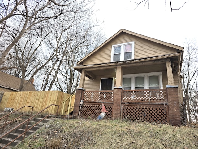 back of property with covered porch