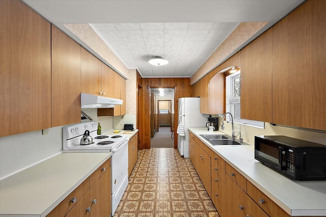 kitchen with sink, white appliances, and baseboard heating