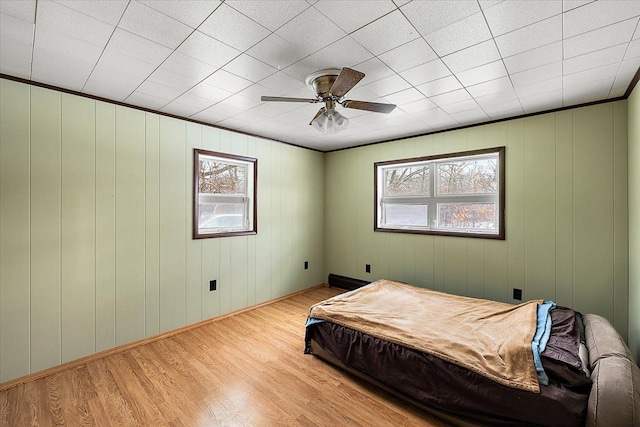 bedroom with multiple windows, pool table, ceiling fan, and light hardwood / wood-style flooring