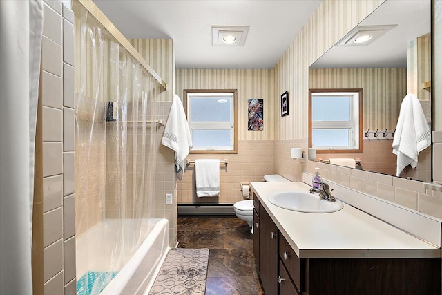 bathroom with tile walls, vanity, and toilet