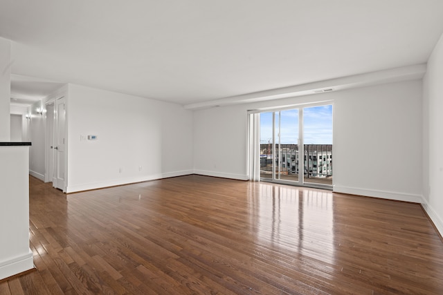 spare room with dark wood-type flooring