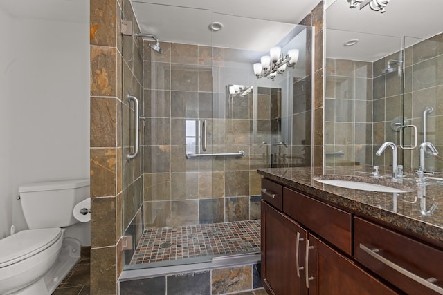 bathroom featuring toilet, walk in shower, and vanity