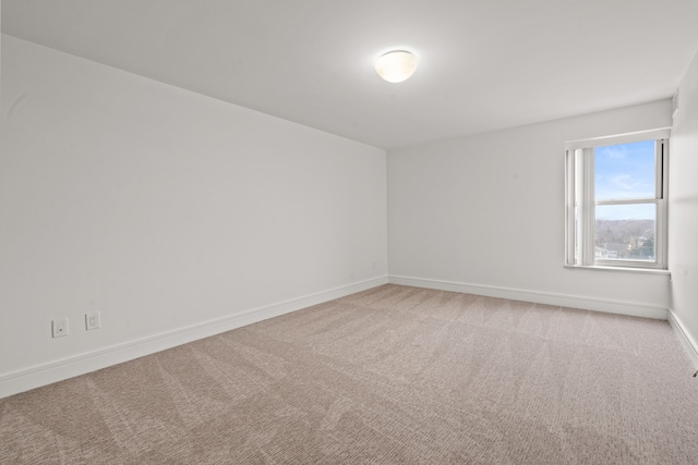 unfurnished room featuring light carpet