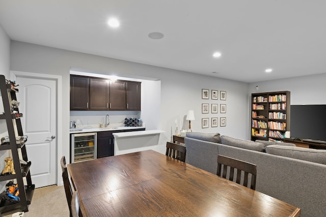 dining room with light carpet, beverage cooler, and wet bar