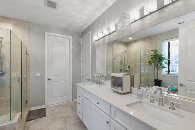 bathroom featuring vanity and a shower with shower door