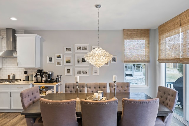 dining area featuring light hardwood / wood-style flooring and an inviting chandelier