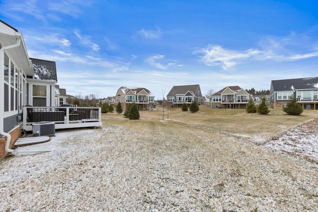 view of yard with central AC and a deck