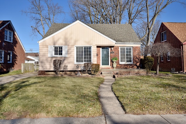 bungalow-style home with a front lawn