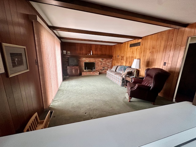 carpeted living room with beamed ceiling, a wood stove, and wooden walls