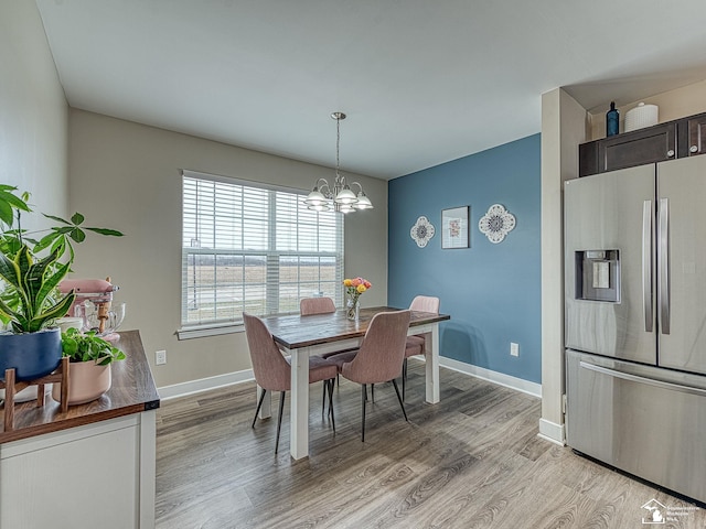 dining room featuring light hardwood / wood-style floors and an inviting chandelier