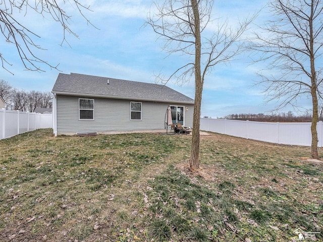 rear view of property with a yard