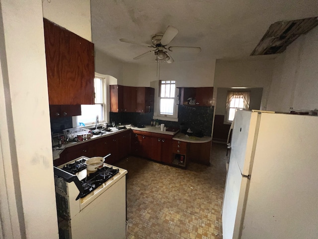 kitchen with white fridge, ceiling fan, and sink