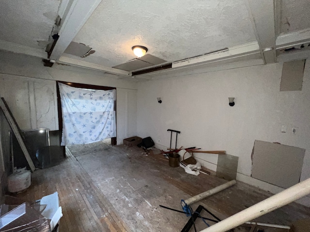 interior space featuring hardwood / wood-style flooring and a textured ceiling