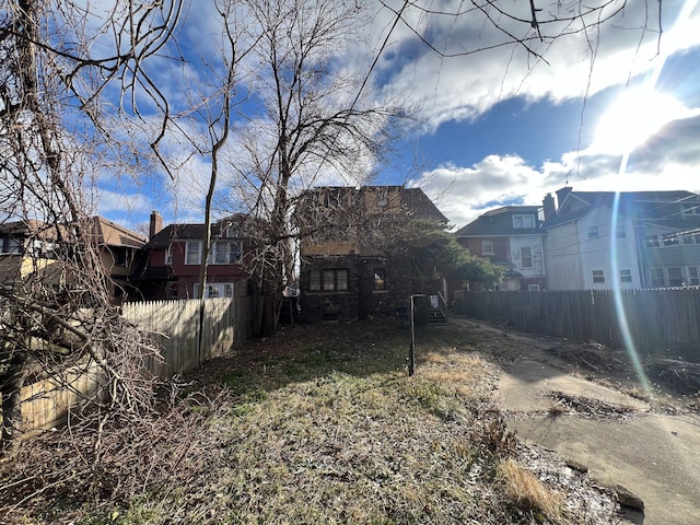 view of yard featuring fence and a residential view