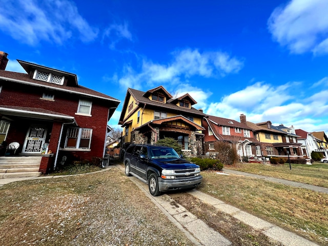 view of front of property with a residential view and brick siding